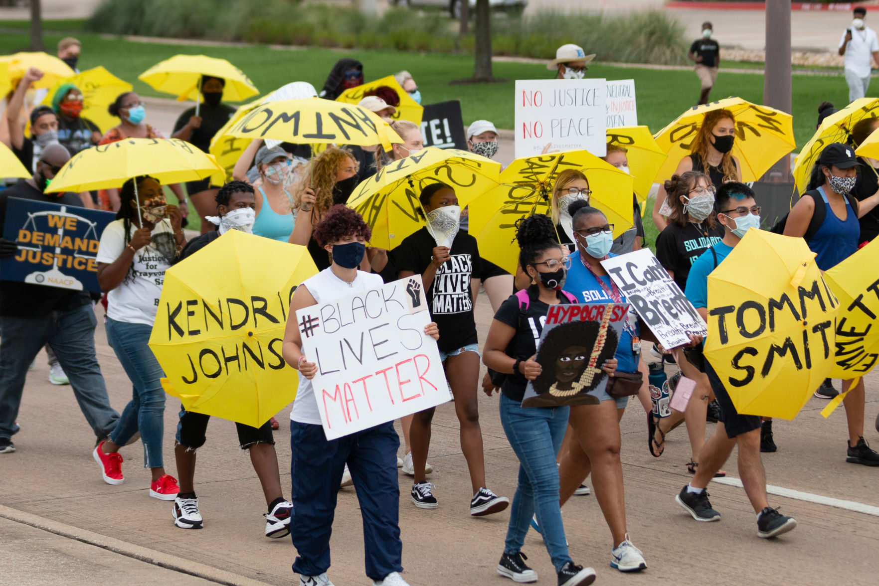Arlington youth march with yellow umbrellas in remembrance of police brutality victims